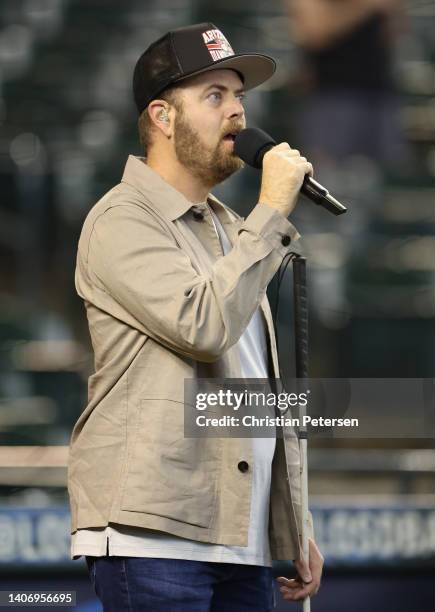 Singer Scott MacIntyre performs the national anthem before the MLB game at Chase Field on June 15, 2022 in Phoenix, Arizona.