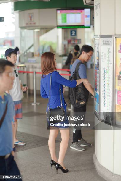 thai commuters are buying tickets  at ticket machine in bts skytrain station - bts bangkok stock pictures, royalty-free photos & images