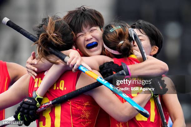 Xindan Zhang of China celebrates with Jiaqi Zhong of China and Jiali Zheng of China during the FIH Hockey Women's World Cup 2022 match between India...