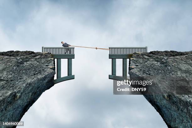 man using rope to bridge the gap - bridging the gap stock pictures, royalty-free photos & images