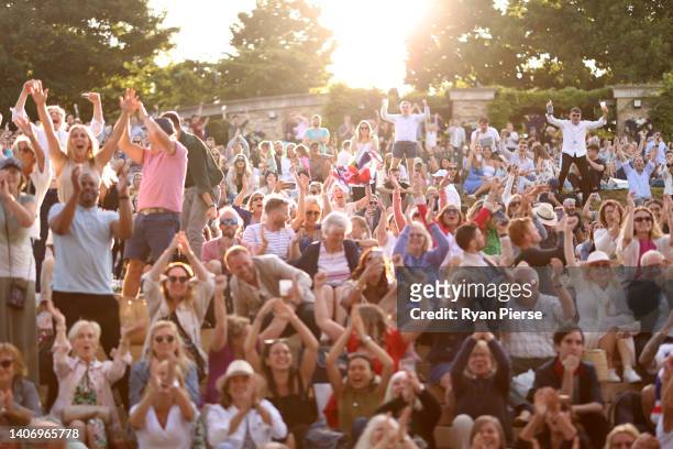 Spectators watch the big screens from The Hill during the Men's Singles Quarter Final match showcasing Cameron Norrie of Great Britain against David...
