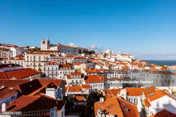 lisbon cityscape with alfama neighbourhood on a sunny day with clear blue sky, portugal - lisbonne photos et images de collection