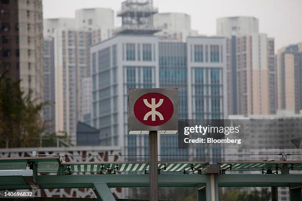 The MTR Corp. Logo is displayed near one of the company's train stations in Hong Kong, China, on Saturday, March 3, 2012. MTR is scheduled to...