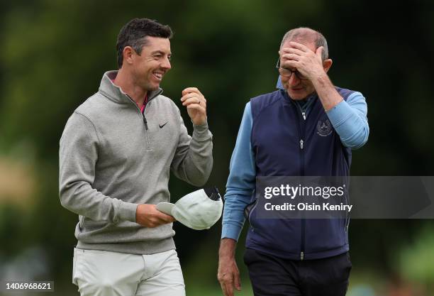 Rory McIlroy of Northern Ireland , shakes hands with former footballer Martin O'Neil as they finish their round during Day Two of the JP McManus...