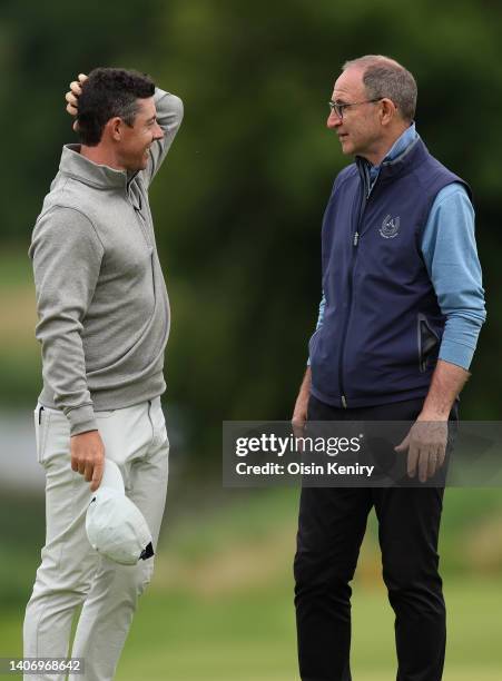 Rory McIlroy of Northern Ireland , shakes hands with former footballer Martin O'Neil as they finish their round during Day Two of the JP McManus...