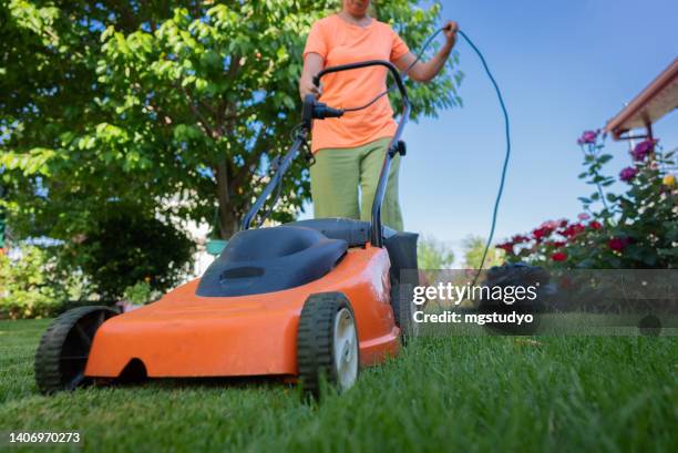 mowing the lawn - lawnmower stock pictures, royalty-free photos & images