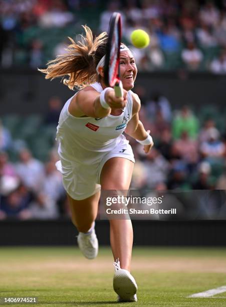 Marie Bouzkova of Czech Republic plays a forehand as they slip against Ons Jabeur of Tunisia during their Women's Singles Quarter Final match on day...