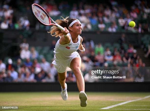 Marie Bouzkova of Czech Republic plays a forehand as they slip against Ons Jabeur of Tunisia during their Women's Singles Quarter Final match on day...