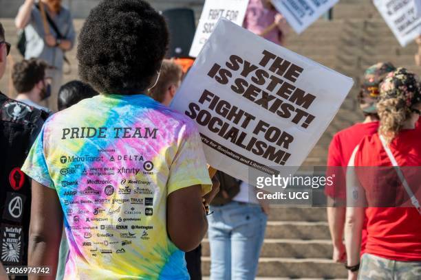 Supporters of abortion rights rally at the capitol following the scrotus ruling Roe V Wade, Woman with a Pride team shirt and socialism sign at the...