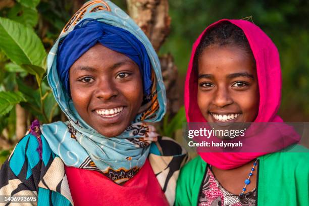 portrait of happy african young girls, east africa - ethiopië stockfoto's en -beelden