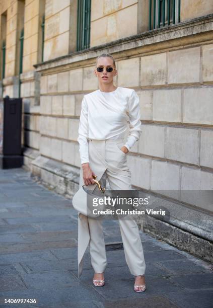 Guest is seen wearing white blouse creme white bag, pants, sunglasses outside Alexis Mabille outside Paris Fashion Week - Haute Couture Fall Winter...
