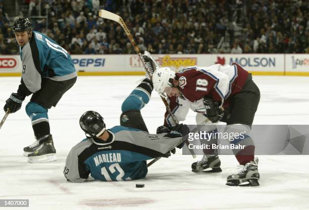 Patrick Marleau of the San Jose Sharks tangles up Chris Drury of the Colorado Avalanche from his seat on the ice in the first period during game one...