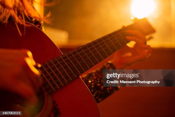 woman playing guitar at music studio - guitarist stock pictures, royalty-free photos & images