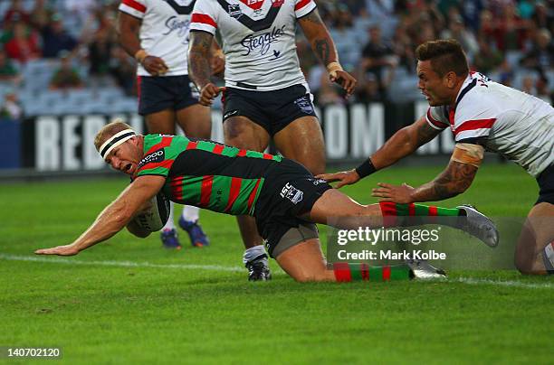 Michael Crocker of the Rabbitohs dives over to score a try during the round one NRL match between the South Sydney Rabbitohs and the Sydney Roosters...