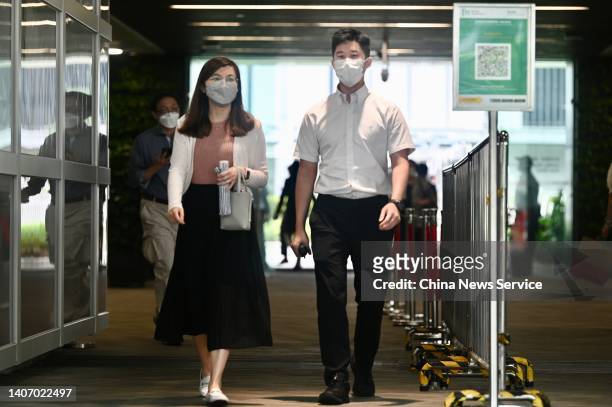 People walk out of the Central Government Offices on July 5, 2022 in Hong Kong, China.