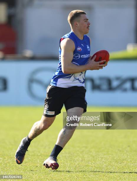 Cameron Zurhaar of the Kangaroos runs with the ball during a North Melbourne Kangaroos AFL training session at Arden Street Ground on July 06, 2022...