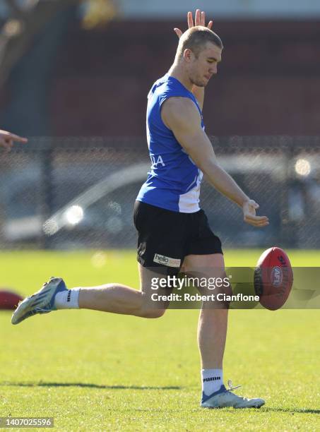 Jason Horne-Francis of the Kangaroos kicks the ball during a North Melbourne Kangaroos AFL training session at Arden Street Ground on July 06, 2022...