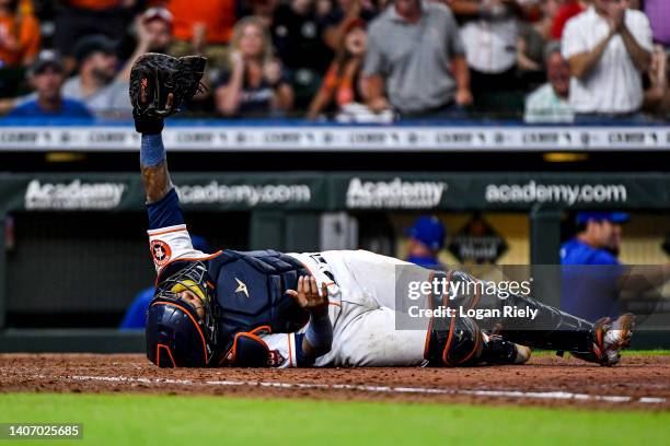 Martin Maldonado of the Houston Astros tags out Hunter Dozier of the Kansas City Royals at Minute Maid Park on July 05, 2022 in Houston, Texas.