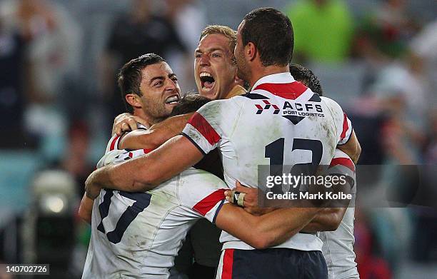 Anthony Minichiello and Mitchell Aubusson of the Roosters celebrate with their team mates after Minichiello scored the match winning try during the...