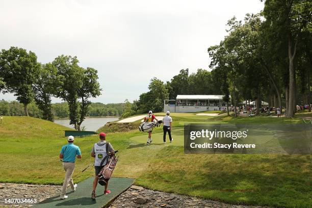 Emiliano Grillo of Argentina and Chris Naegel of the United States walk to the 16th green during the third round of the John Deere Classic at TPC...