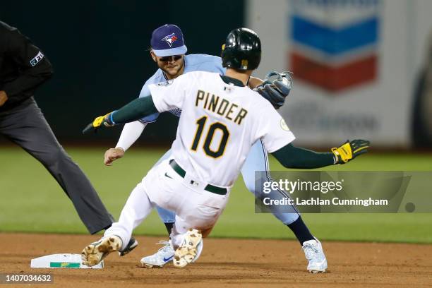 Bo Bichette of the Toronto Blue Jays tags out Chad Pinder of the Oakland Athletics at second base in the bottom of the eighth inning at RingCentral...