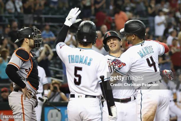 Daulton Varsho of the Arizona Diamondbacks is congratulated by Ketel Marte and Alek Thomas after hitting three-run home run against the San Francisco...