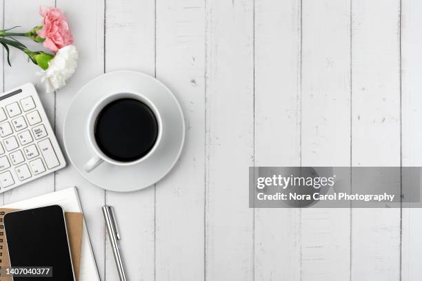 office desk with cup of coffee, carnation flower, computer keyboard and smart phone - smart phone white background stock pictures, royalty-free photos & images