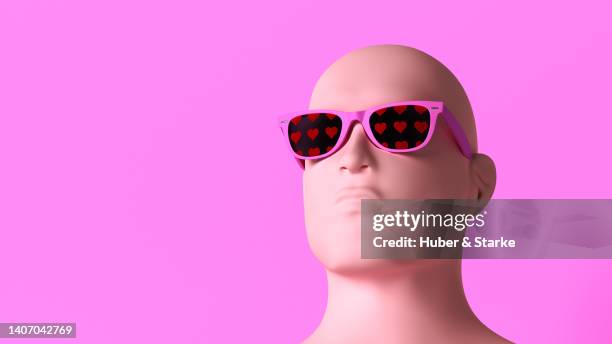 head of bust wearing sunglasses with heart pattern against pink background - modern sculpture stock pictures, royalty-free photos & images