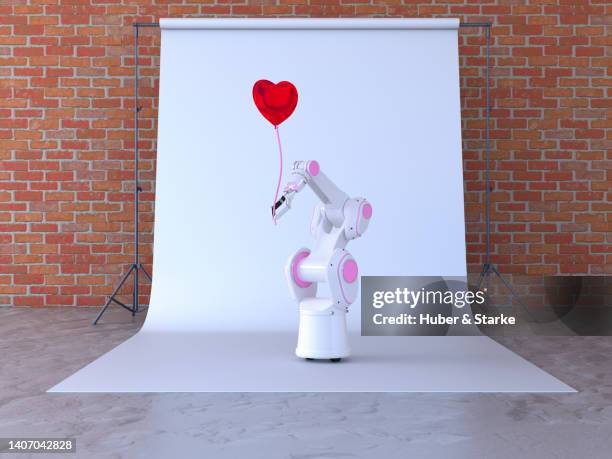 robotic holding heart as balloon - hohlkehle stock-fotos und bilder