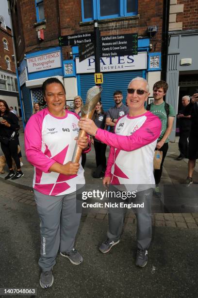 Baton bearers Darren Smith and Lorraine Shaw hold the Queen's Baton during the Birmingham 2022 Queen's Baton Relay on a visit to Gloucester, United...