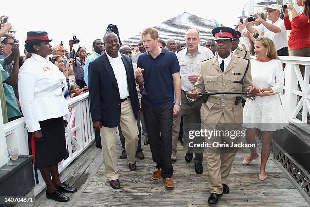 Prince Harry is escorted by India Hicks cheered by crowds as he visits Harbour Island on March 4, 2012 in Nassau, Bahamas. The Prince is visiting the...