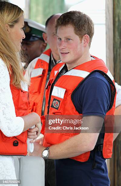Prince Harry talks to India Hicks as he visits Harbour Island on March 4, 2012 in Nassau, Bahamas. The Prince is visiting the Bahamas as part of a...
