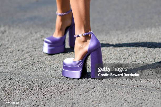 Chloe Lecareux wears purple satin Medusa Aevitas platform pumps heels shoes from Versace, outside Alexandre Vauthier, during Paris Fashion Week -...