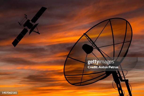 satellite dish and satellite at sunset. satellite communication concept - receiver - fotografias e filmes do acervo