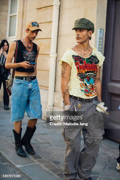 Two guests exit the Ronald Van der Kemp Fall/Winter 22 Couture show at Hôtel d'Avaray in 90s punk style on July 05, 2022 in Paris, France. On the...