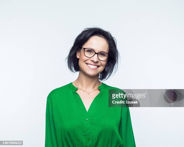 portrait of smiling mature women - green dress stock pictures, royalty-free photos & images
