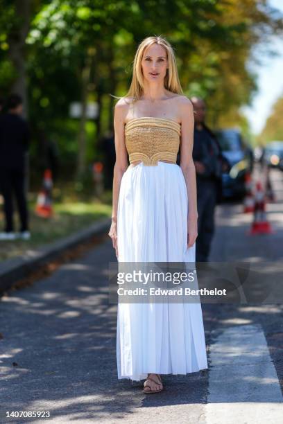 Lauren Santo Domingo wears a beige braided wicker shoulder-off / cropped top, a high waist white pleated long skirt, brown suede strappy sandals ,...