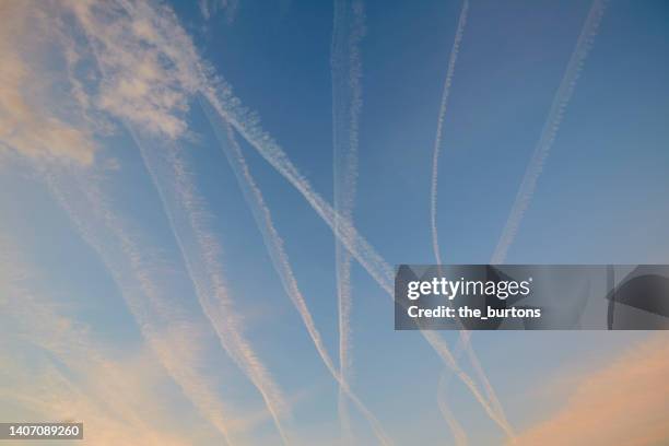 airplane contrails, abstract background - sunset with jet contrails stock pictures, royalty-free photos & images