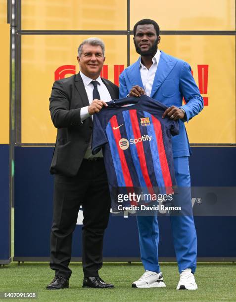 Franck Kessie and FC Barcelona President Joan Laporta pose for the media as he is presented as a FC Barcelona player at Ciutat Esportiva Joan Gamper...