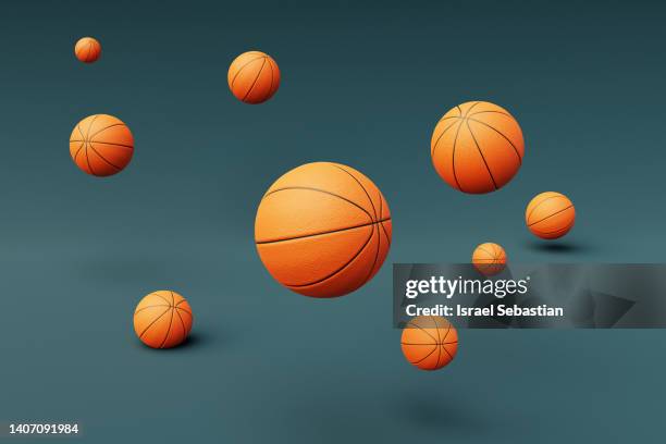 digitally generated image of basketballs flying on blue background. - 籃球 球 個照片及圖片檔