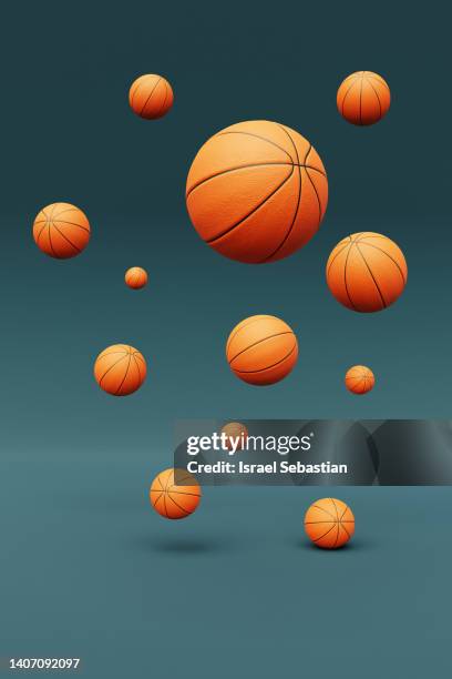 digitally generated image of basketballs flying on blue background. - sport blue background stock-fotos und bilder