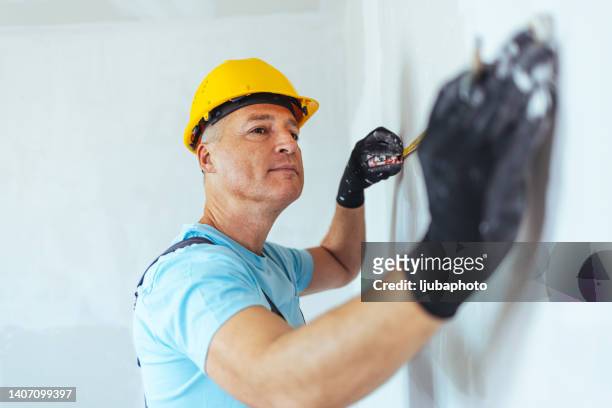 construction worker with tape measure on site - 50 meter stock pictures, royalty-free photos & images