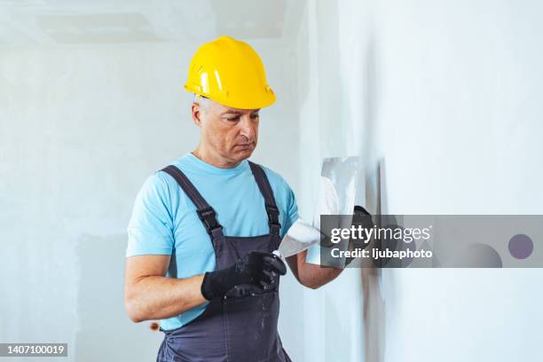 construction worker during interior decoration - plasterer stock pictures, royalty-free photos & images