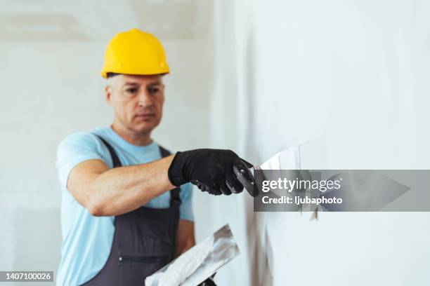 finishing drywall walls - spatula stock pictures, royalty-free photos & images