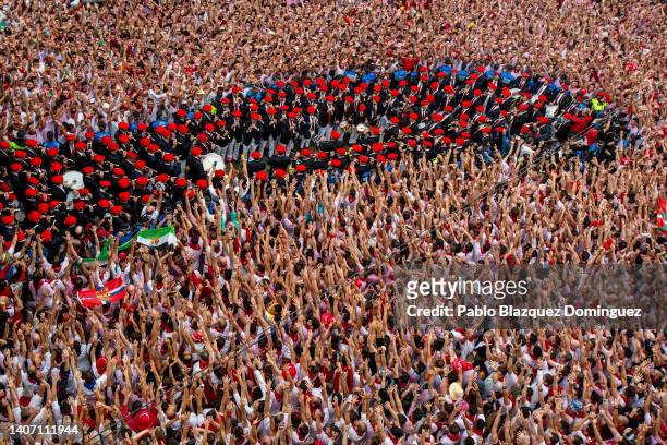 Revellers rise their hands as a music band makes its way thought the crowd during the opening day or 'Chupinazo' of the San Fermin Running of the...