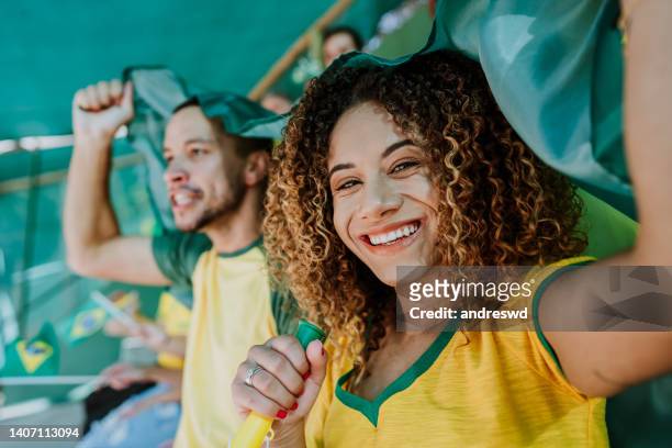 happy brazilian fans at the stadium - international soccer event stock pictures, royalty-free photos & images