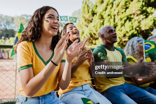 happy brazilian fans celebrating goal - a brazil supporter stockfoto's en -beelden