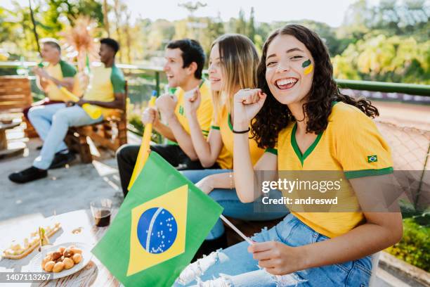 happy brazilian fans celebrating goal - female fans brazil stock pictures, royalty-free photos & images