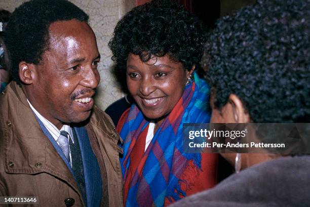 Winnie Mandela speaks to Chris Hani at the Swedish parliament while on a five-day state visit, with husband Nelson Mandela, to Sweden on March 13 in...