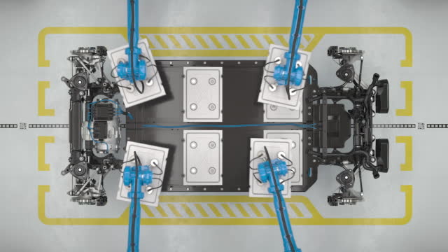 Top view of robots assembling the battery module of an electric car